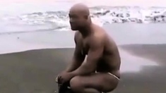 Asian bodybuilder barely covered at the beach